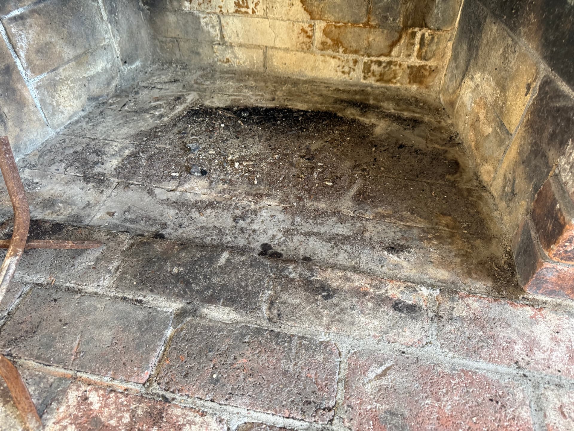 Fireplace firebox with ash and creosote buildup before deep cleaning — photo 2