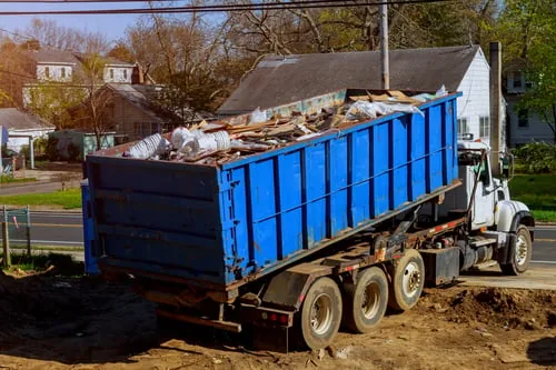 Loaded roll-off container ready for junk removal from a residential property